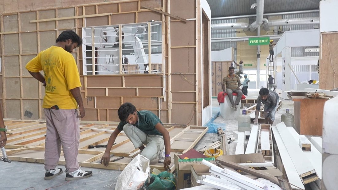 Crew framing a stall wall in the workshop